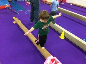 Madiana at gymnastics practicing the balance beam