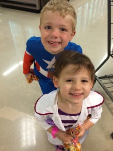 Doc McStuffins (Madiana) and Captain America (Brecken) getting candy at the Grocery store