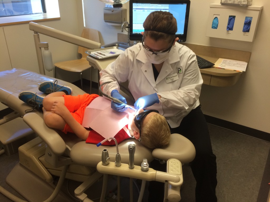 Brecken wearing the shades while the Dentist works.