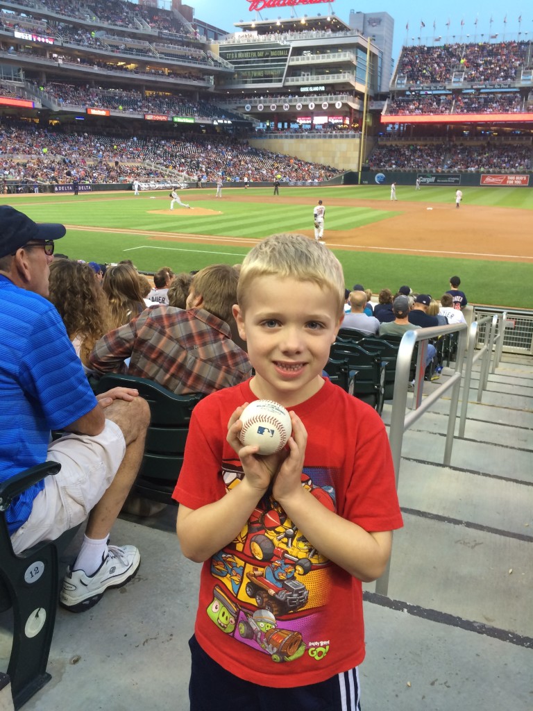 Brecken with a baseball from the game